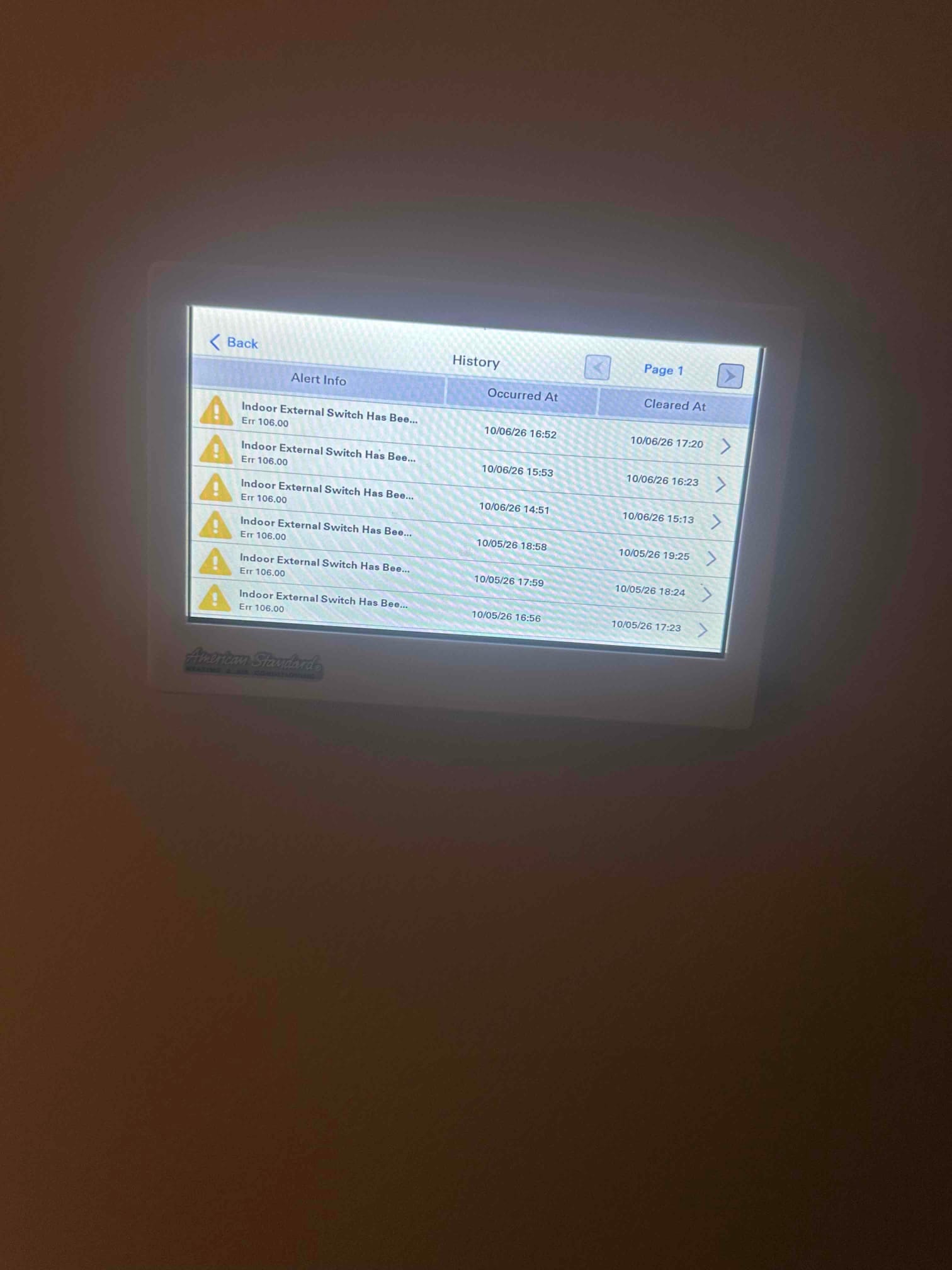 Thermostat touchscreen displays history page with multiple alerts and timestamps for recent indoor external switch events.