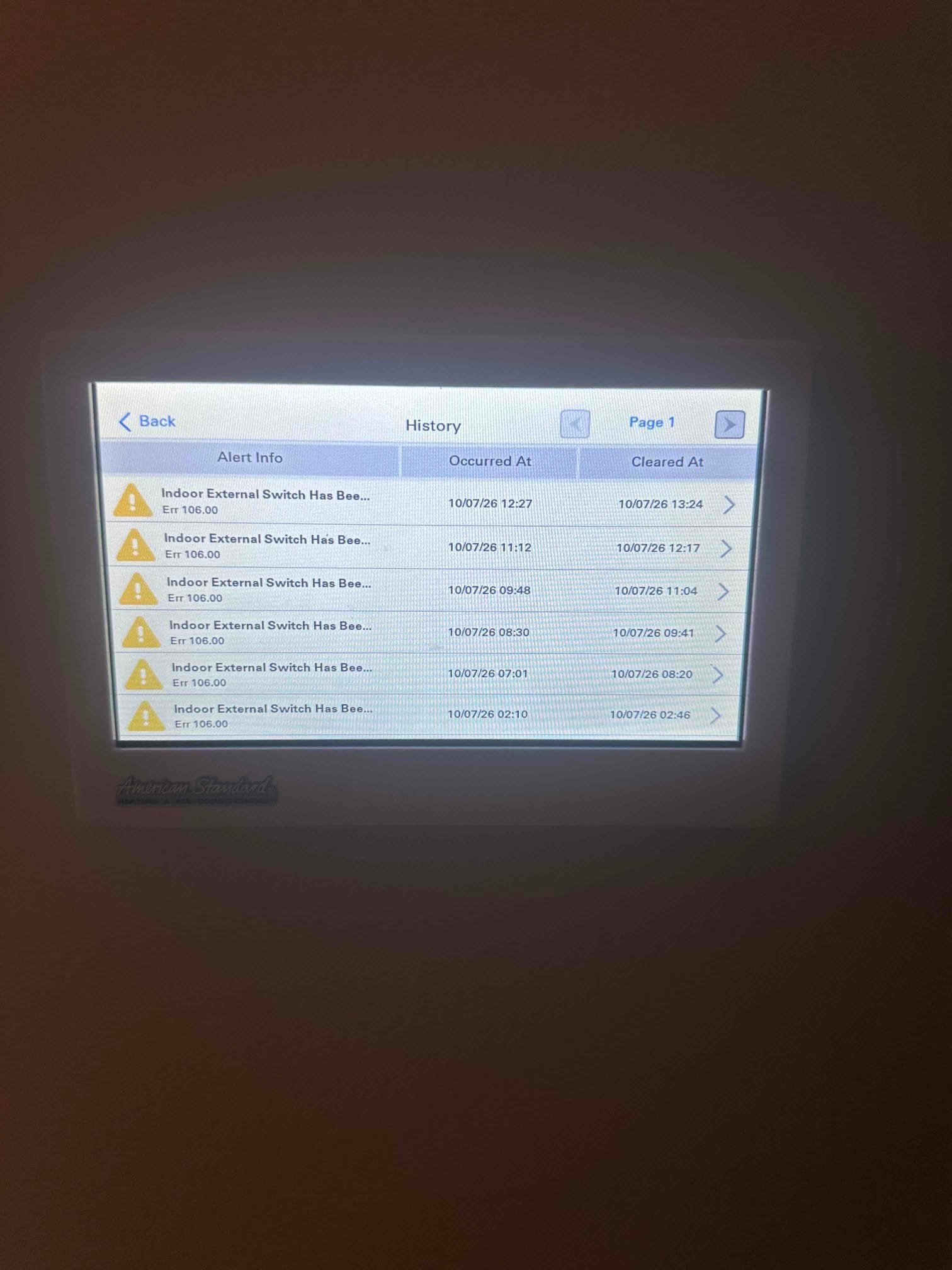 Thermostat touchscreen shows multiple alert history entries for indoor external switch with occurred and cleared timestamps.