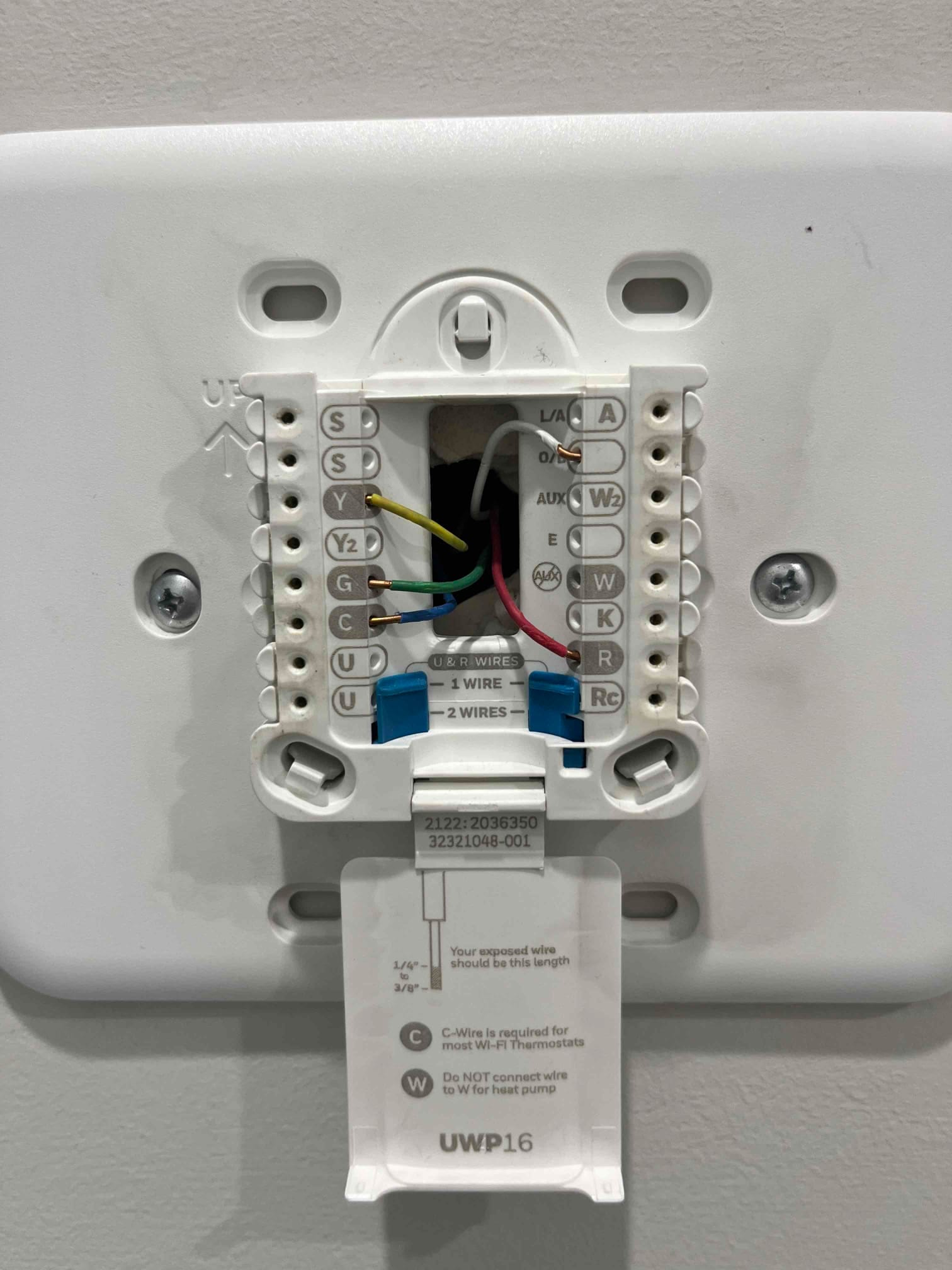 Thermostat wall plate with R, Rc, Y, G, and W terminals wired, mounting screws and wire-length guide visible.
