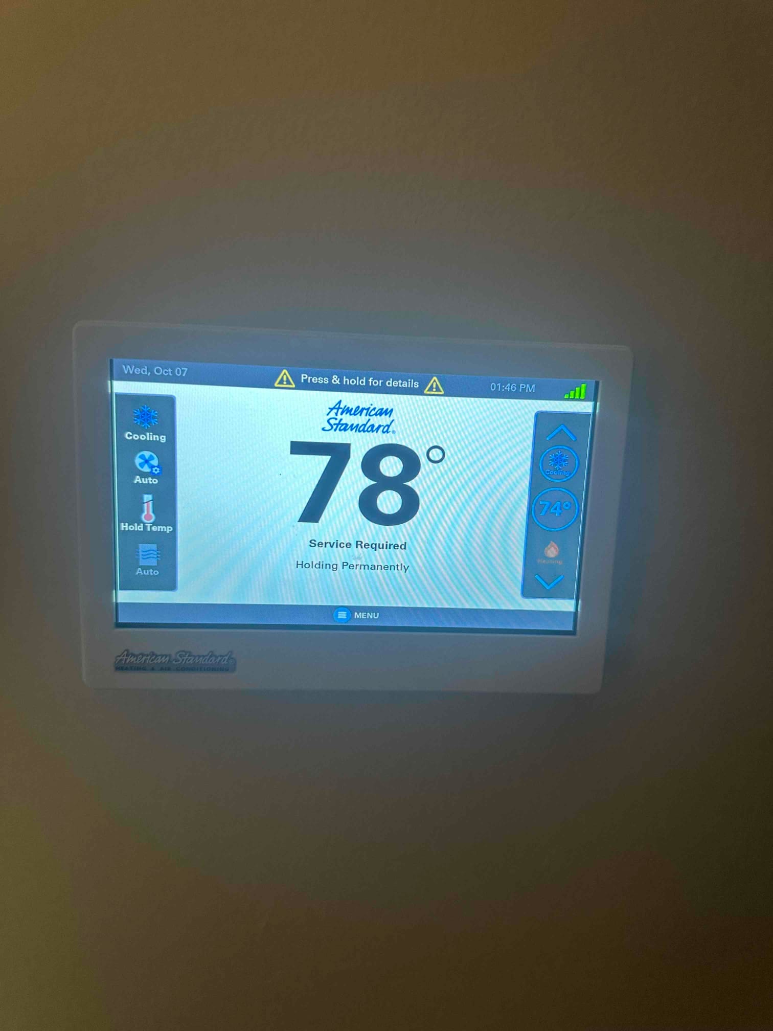 Touchscreen thermostat display shows 78° with cooling mode icons and a service required alert message.