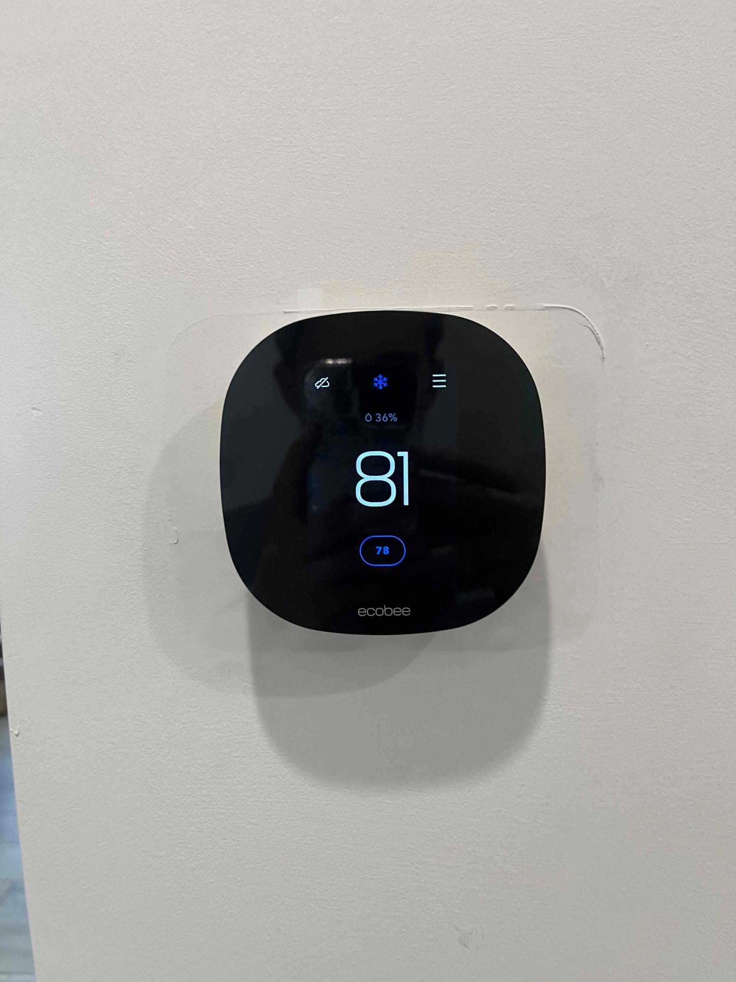 Wall-mounted smart thermostat shows cooling mode active, indoor temperature 81, and setpoint 78.