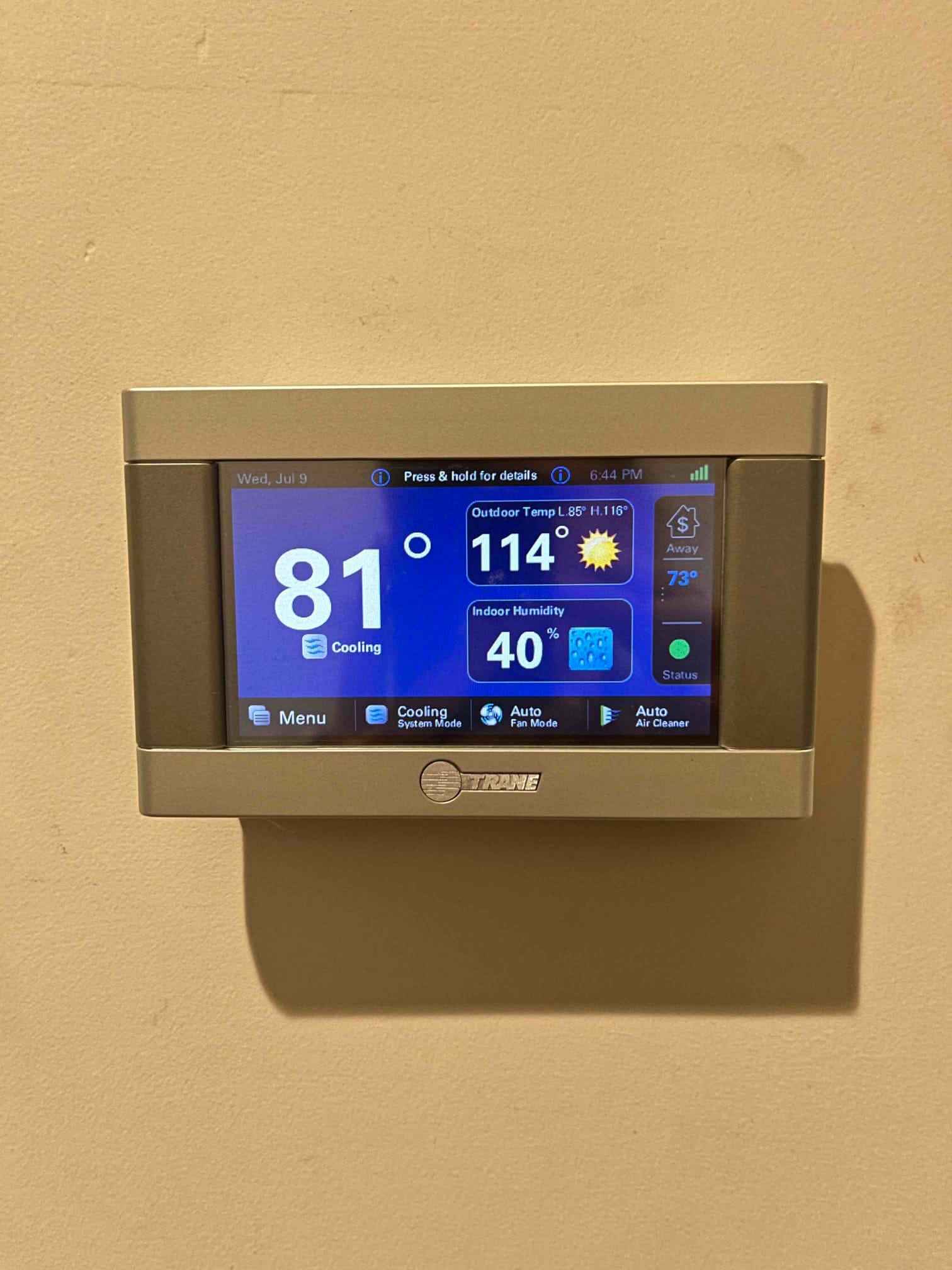 Wall-mounted thermostat screen shows indoor temperature 81°F, outdoor temperature 114°F, and indoor humidity 40 percent during cooling mode.