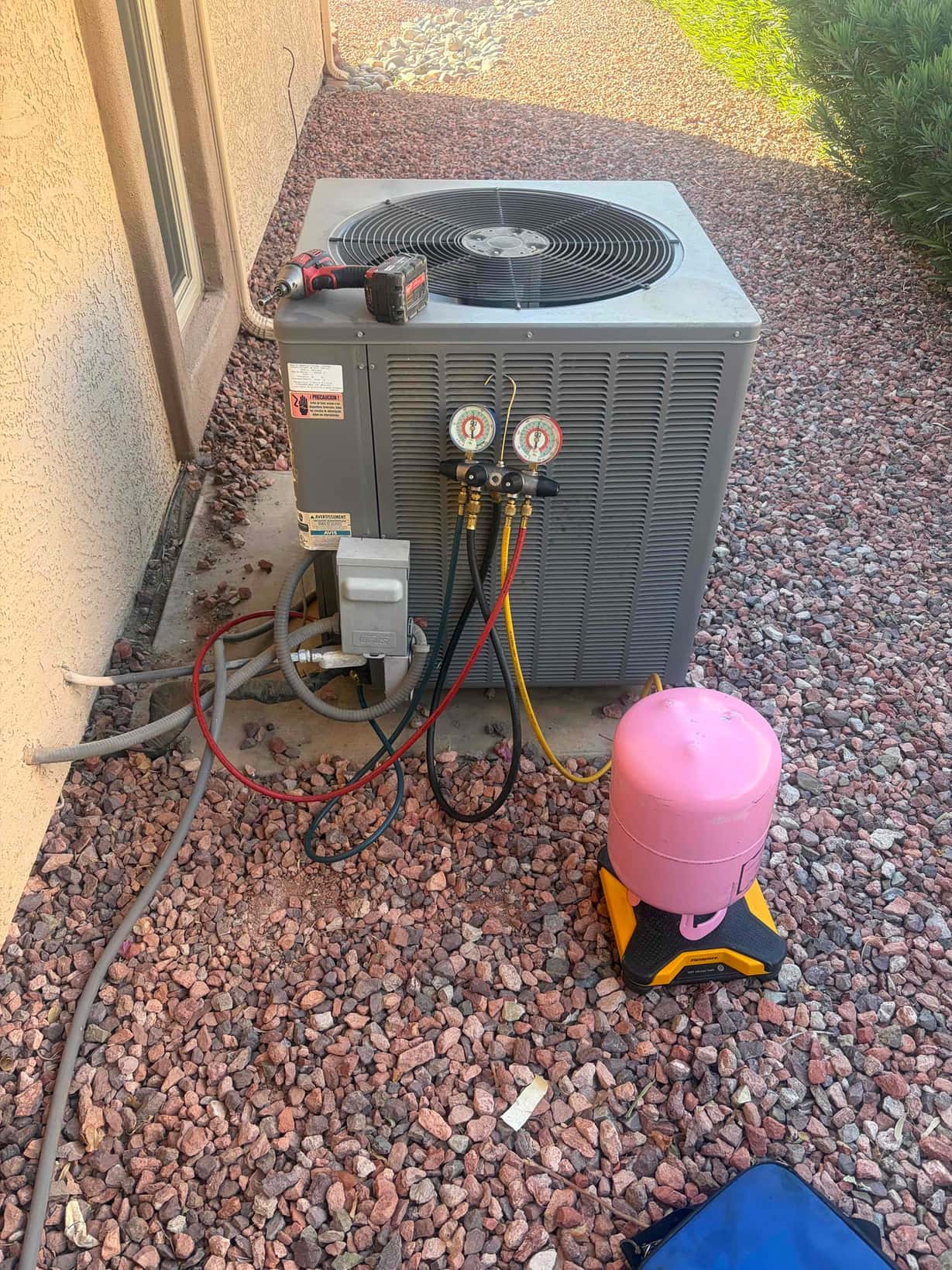 Refrigerant scale photographed during the service visit; no numerical reading is transcribed.