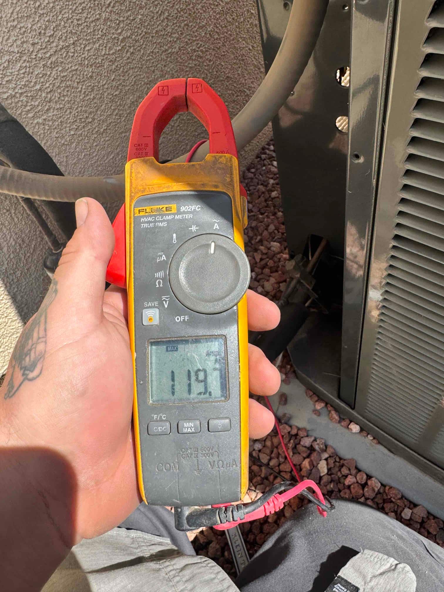 Diagnostic instrument display shows 119.7 V.