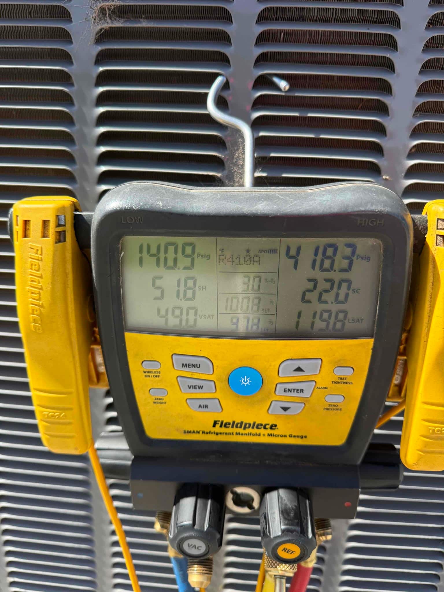 HVAC diagnostic instrument photographed during the service visit.