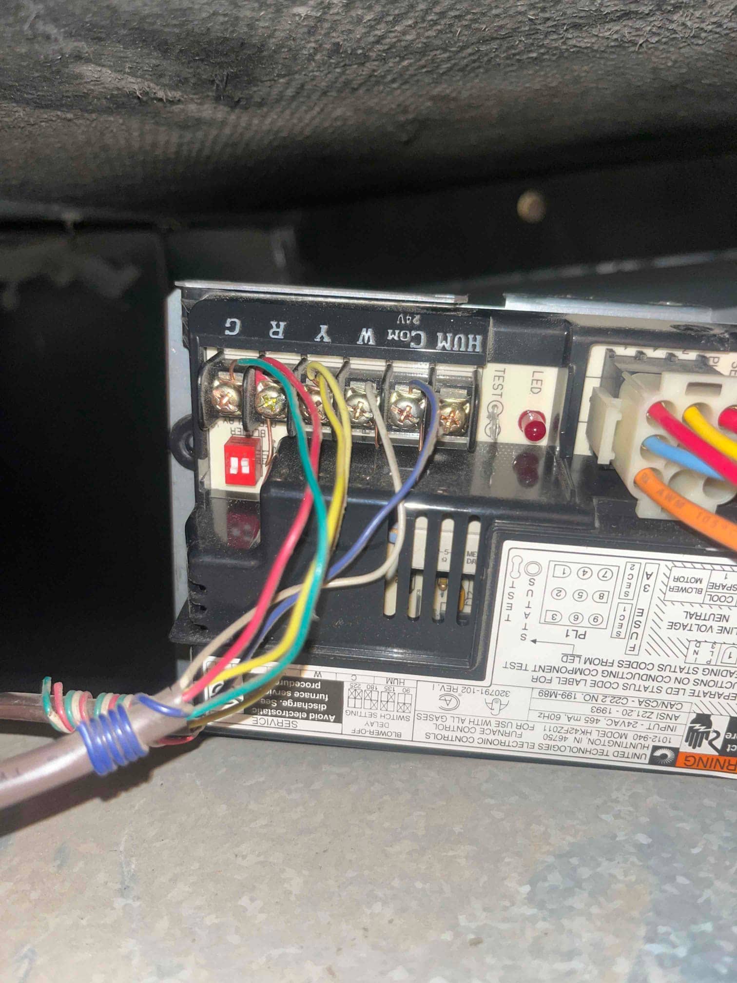 Furnace control board with thermostat wires connected to terminals labeled G, R, C, W, Y, and HUM.