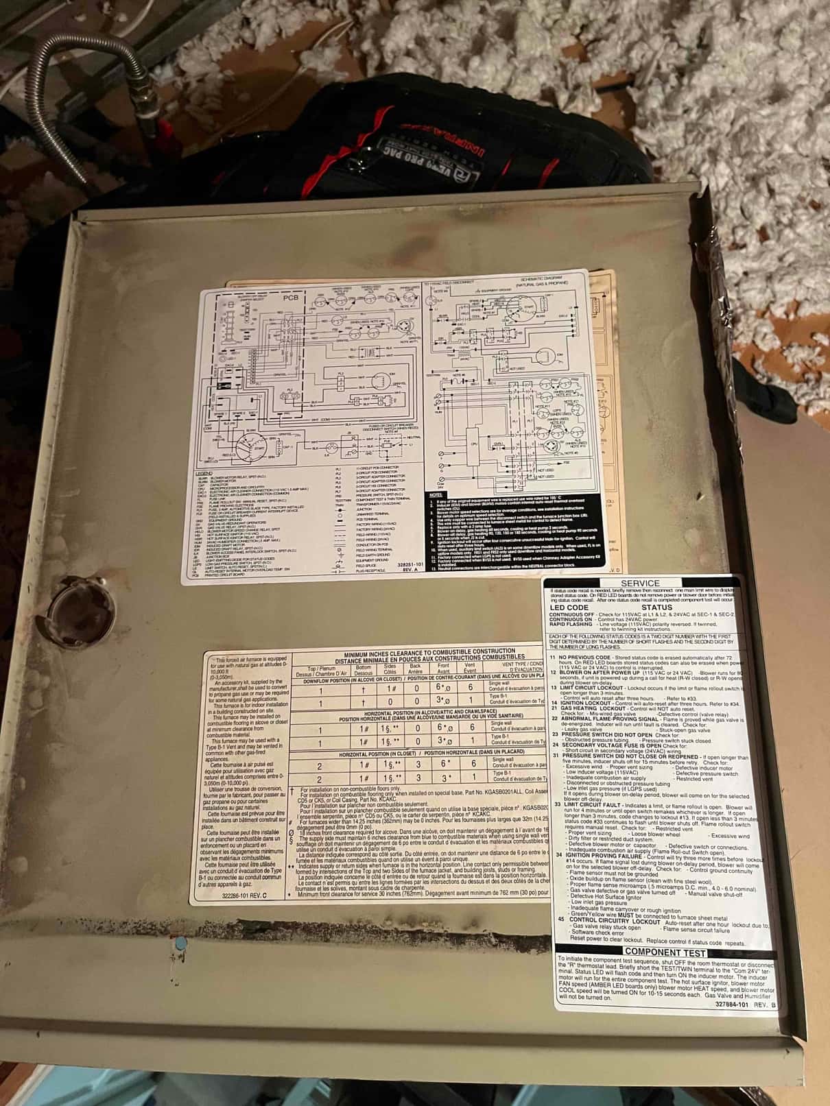 HVAC unit access panel with wiring diagram and service instruction labels affixed to the surface.