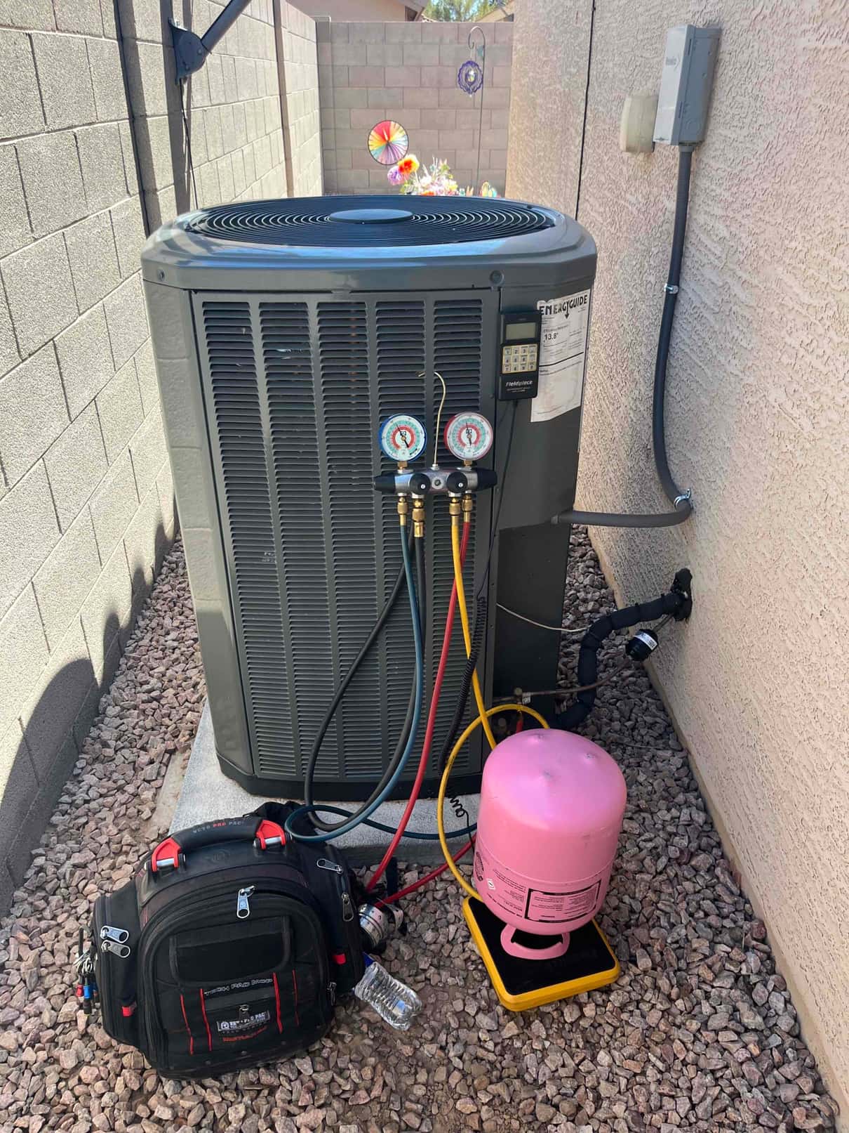 Refrigerant scale photographed during the service visit; no numerical reading is transcribed.