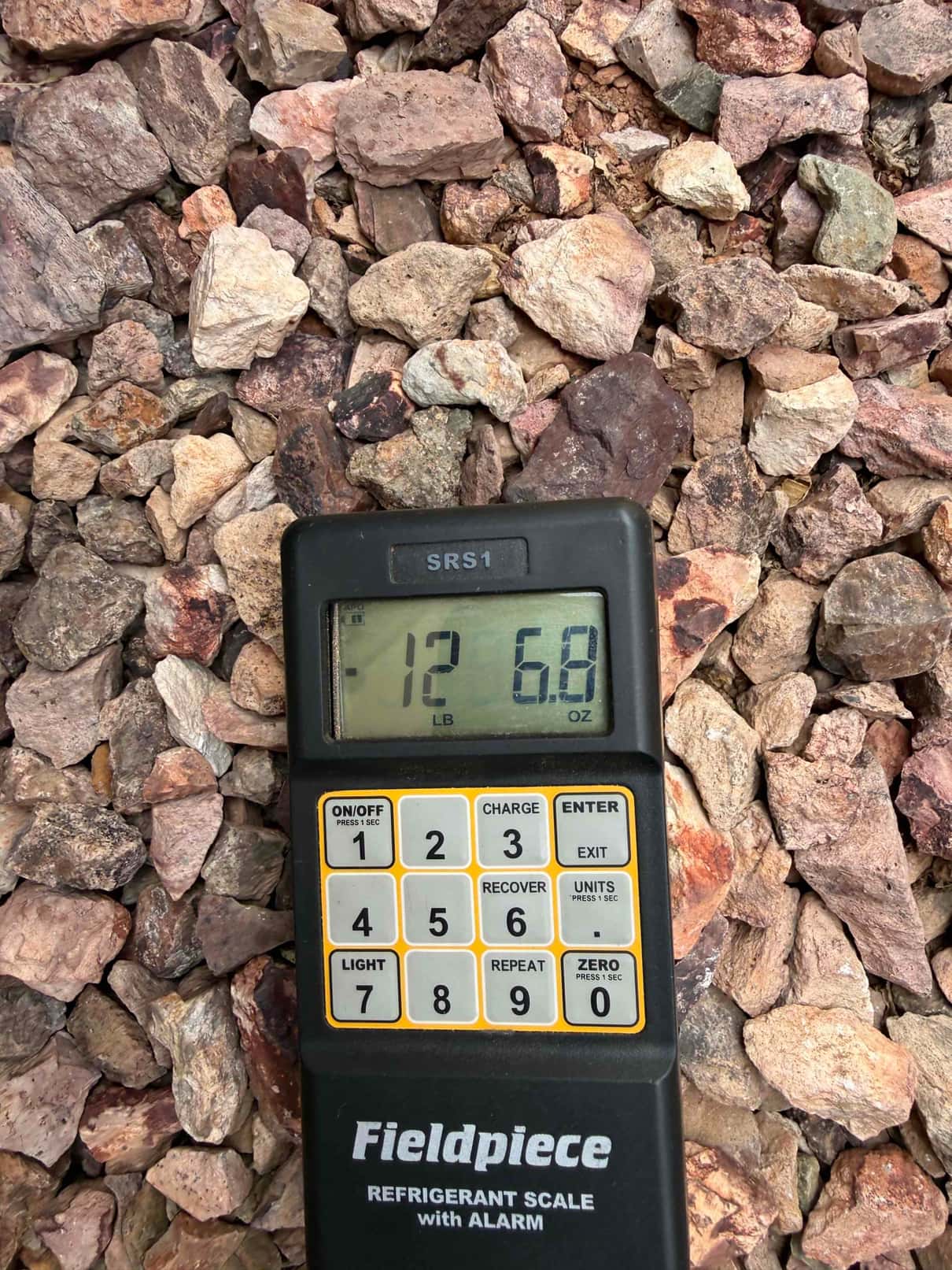 Refrigerant scale photographed during the service visit; no numerical reading is transcribed.