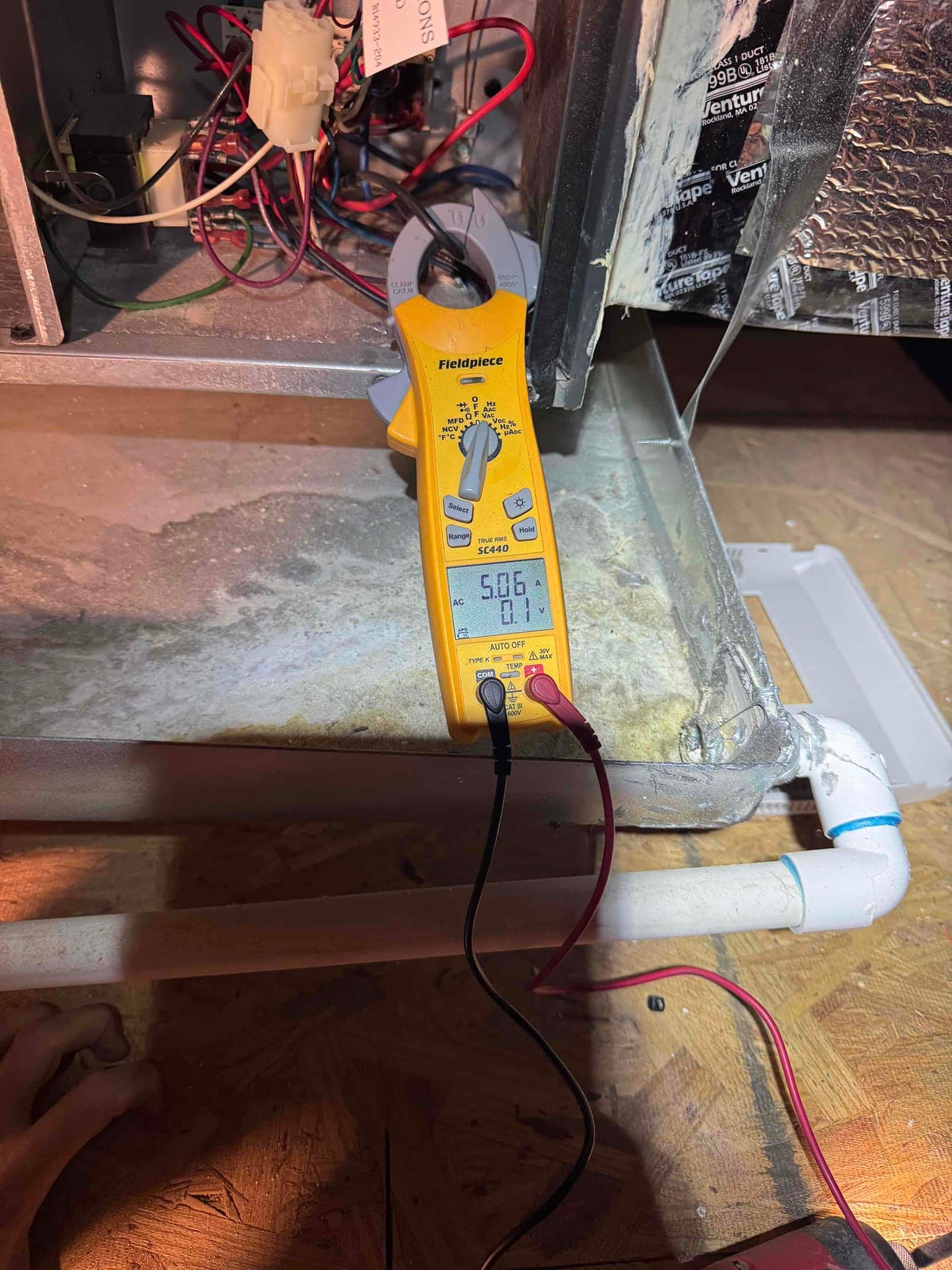 HVAC diagnostic instrument photographed during the service visit.